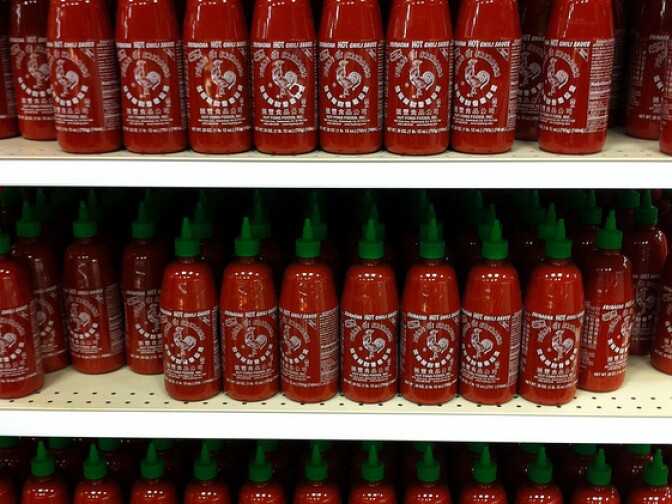 Bottles of Sriracha hot sauce in a supermarket. 