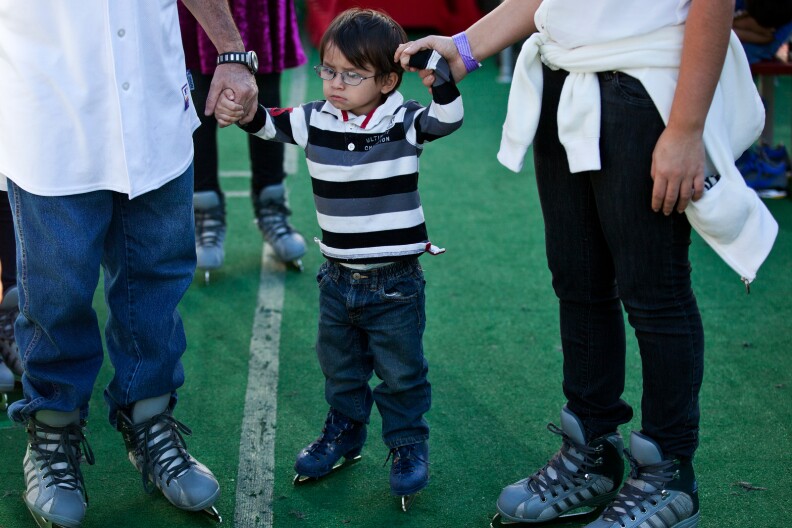 Two-year-old Baby James gets ready to skate for his first time during Downtown on Ice at Pershing Square on Christmas Eve.