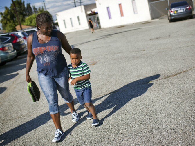 Monique McClendon, a paralegal student at Los Angeles Trade-Tech College, picks up her 3-year-old son, Justin, from daycare near the Los Angeles International Airport on Wednesday July 29, 2015. A year ago, doctors diagnosed Justin's condition as lead poisoning.