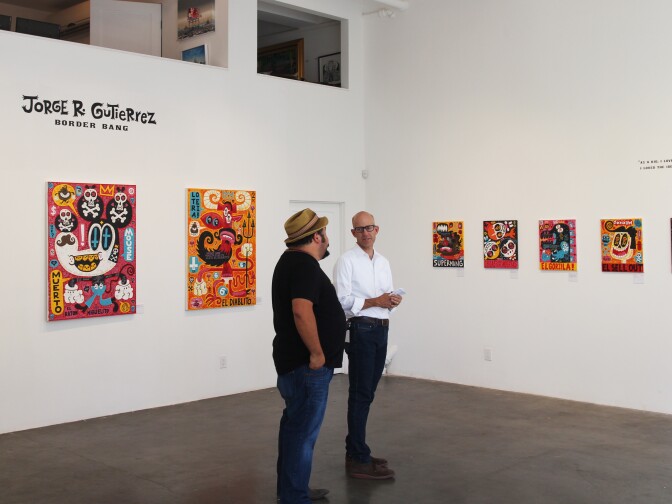 Artist Jorge Gutierrez and Frame host John Horn inside the Gregorio Escalante Gallery in Chinatown for the Border Bang show. 