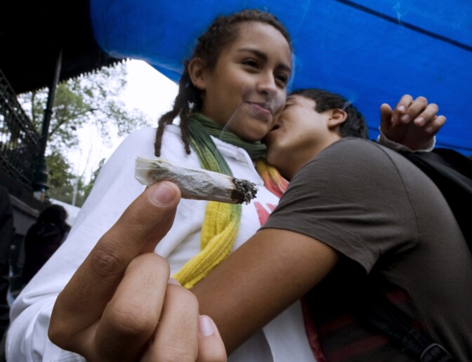 A couple dances and smokes a joint during a rally for the legalization of marijuana in Mexico City, on September 5, 2010. AFP PHOTO / Luis ACOSTA (Photo credit should read LUIS ACOSTA/AFP/Getty Images)
