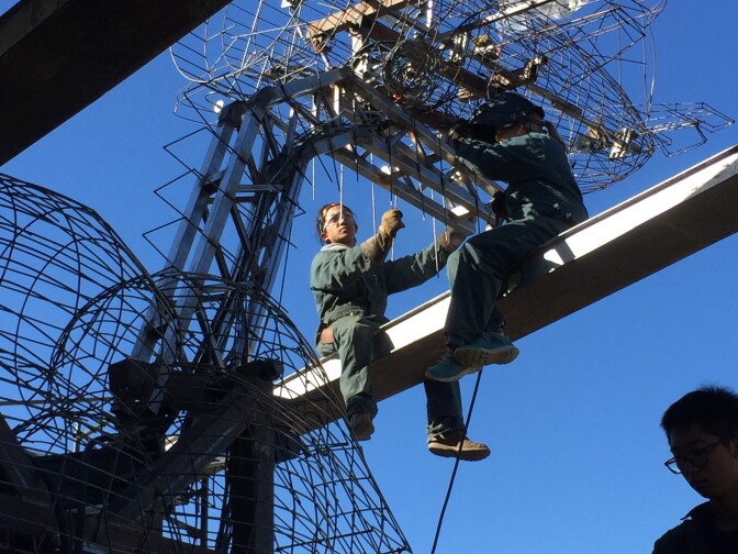 Wireframe of Rusty and his airplane from the back as students rush to complete the Cal Poly Universities Rose Float.