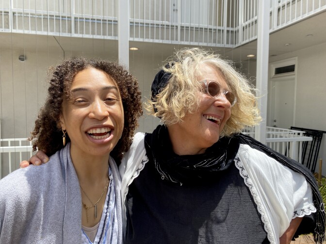 Sumaiyya is photographed with her case manager, Sherita, at her new apartment. Both are smiling. 