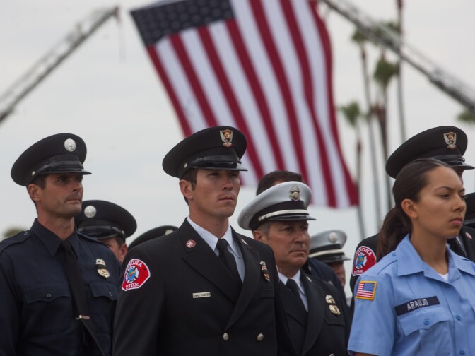 A firefighter takes part in a funeral procession at Los Alamitos Air Field in Orange County.