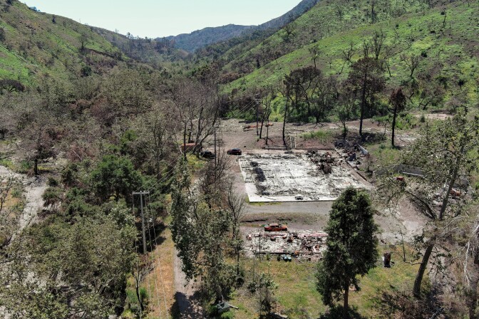 An aerial photo of Camp Josepho shows the charred remnants of a building and burned cars. 