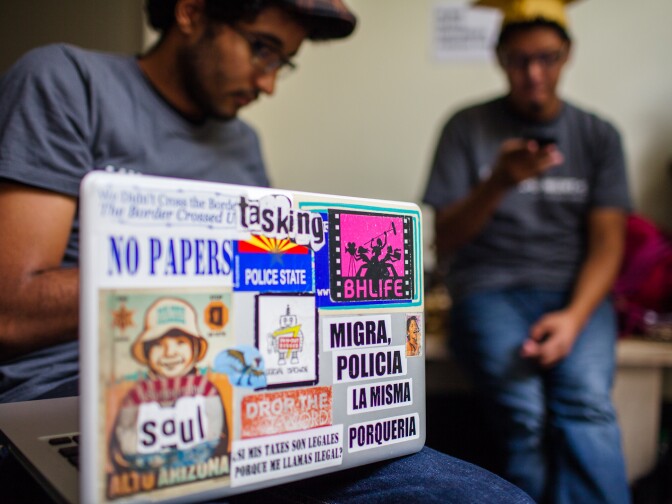Jonathan Perez's computer displays a multitude of stickers expressing his belief that undocumented youth in the U.S. should be granted citizenship.