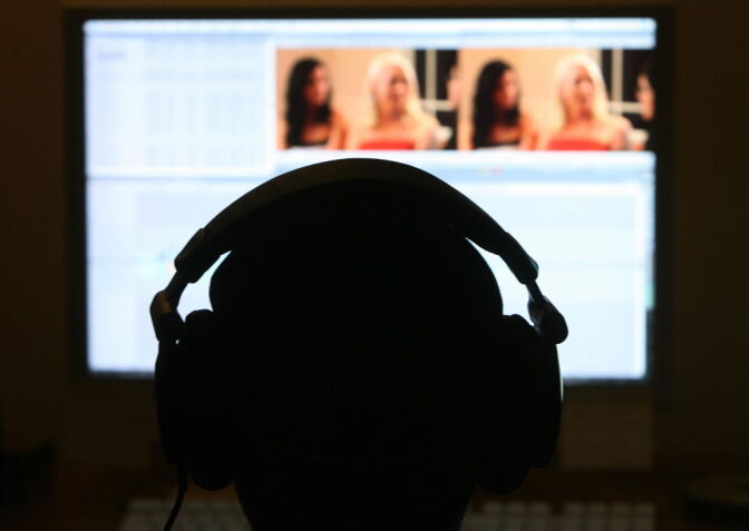 Los Angeles, UNITED STATES: A technician edits a pornographic movie at the Vivid Entertainment studio 30 January 2007 in Los Angeles. Blotches, blemishes and the occasional patch of cellulite: the high definition entertainment revolution has raised some hitherto unforeseen headaches for purveyors of pornography.   But as his company prepares to release its first ever adult film on next generation Blu-Ray and HD-DVD discs, Vivid Entertainment chief Steve Hirsch is adamant the growing pains of 'hi-def' have been overcome.  