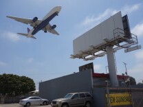                                An airport-adjacent billboard could come down under a new sign ordinance approved for Los Angeles International Airport.