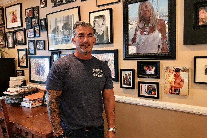 Paul Wilson stands next to a photo of his late wife, Christy Wilson (in white) on Aug. 17, 2017. Christy Wilson was one of eight victims of a 2011 shooting at a beauty salon in Seal Beach. An Orange County judge will decide on Aug. 18 whether the state can pursue the death penalty against confessed shooter Scott Dekraai.  