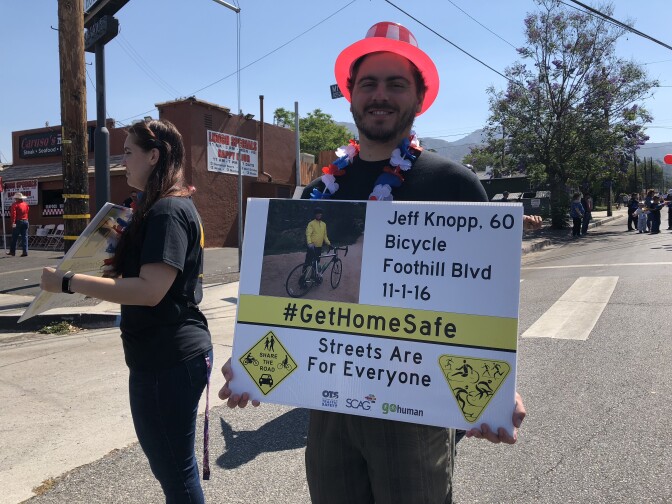 Kevin Knopp holds a sign featuring a photo of his dad, Jeff Knopp. His dad was killed in an accident on Foothill Boulevard almost two years ago. Now, there is a bike lane where his father, Jeff, was struck.
