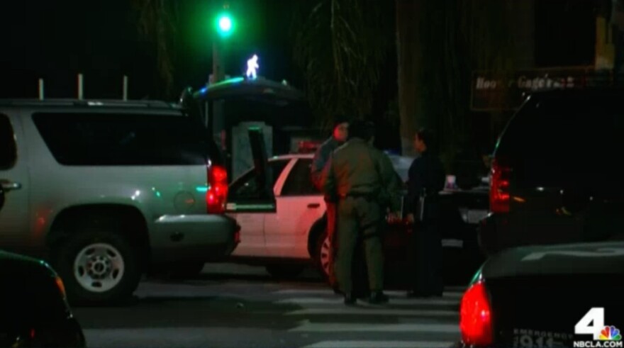 A man opened fire on a police car in South Los Angeles Sunday night, but no one was hurt. The suspect was eventually arrested, and police searched for a second suspect without success.