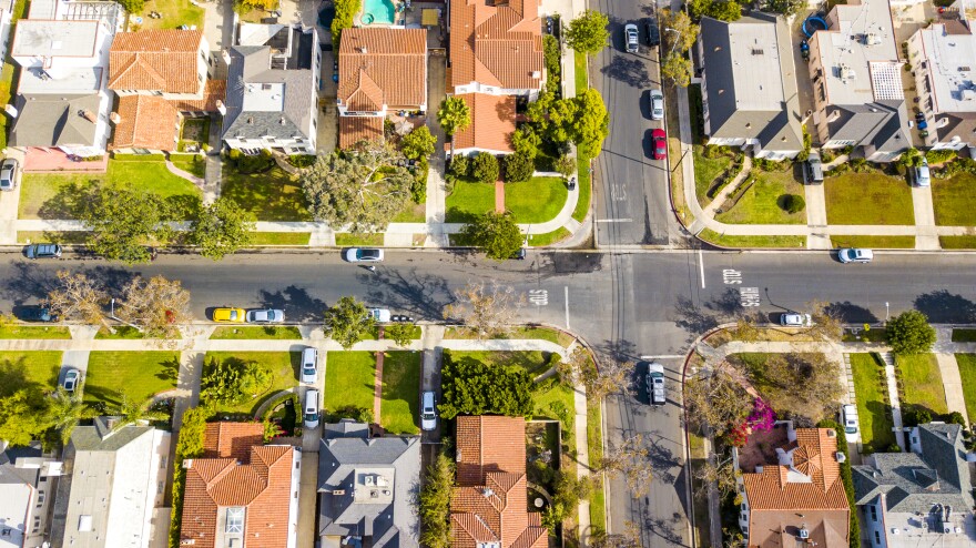 An aerial view of large homes with grassy lawns