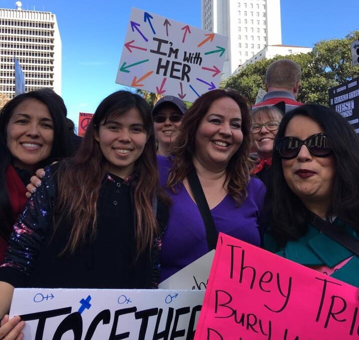 Nubia Cedeño, a resident of Long Beach, at left, along with other parents, educators from her community at the Women's March Los Angeles.