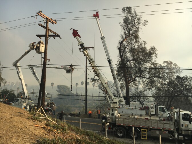 Repair crews replacing power poles and electrical lines that were burned in the Thomas Fire along Highway 150 north of Santa Paula Dec. 6, 2017.