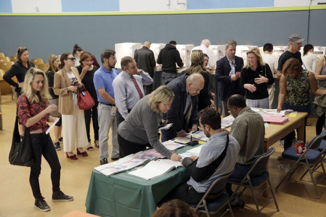 In this Nov. 8, 2016, file photo, people vote at a polling place set up at the Kenter Canyon Elementary School in Los Angeles. Tweets alone don’t make it true. Donald Trump won the presidency earlier this month even as he lost the popular vote to Democrat Hillary Clinton, according to The Associated Press’s vote-counting operation and election experts. Trump nonetheless tweeted on Nov. 26 that he won the popular vote. and alleged there was “serious voter fraud” in California, New Hampshire and Virginia. There’s no evidence to back up those claims. (AP Photo/Nick Ut, file)