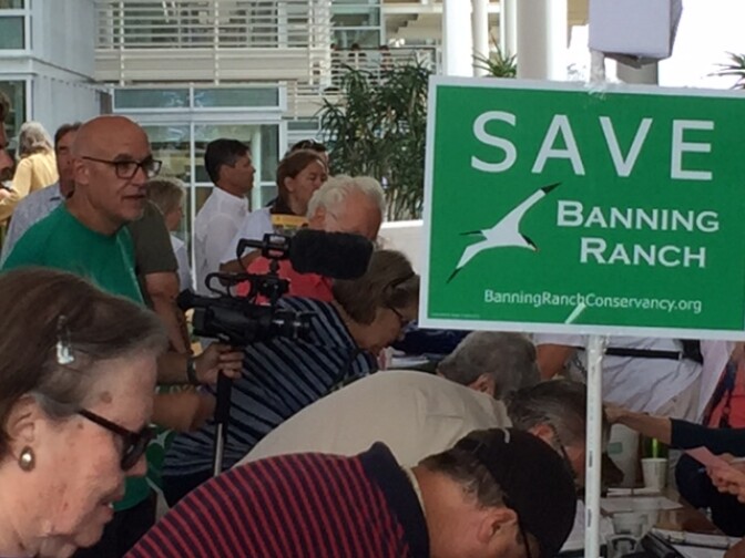 Protesters packed the Coastal Commission meeting Wednesday. Commissioners will decide on whether a large shopping and residential development will be allowed to build on a stretch of coastal land. 