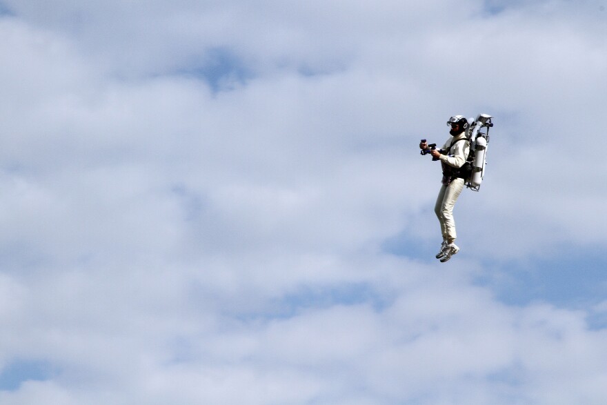 JetPack Man flies through the air and onto the frontstretch to present TMS President Eddie Gossage and SMI Chairman Bruton Smith with the “No Limits” flag that flew on the final Space Shuttle mission with Atlantis prior to the NASCAR Sprint Cup Series AAA Texas 500 at Texas Motor Speedway on November 6, 2011 in Fort Worth, Texas.  