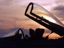 USS CONSTELLATION - JANUARY 15:  A U.S. Navy flight crewman works in the cockpit of a U.S. Navy F/A-18 Hornet after returning to base aboard the USS Constellation January 15, 2003 which is currently in the Persian Gulf area. The Hornets are flying patrol missions in the Iraqi southern no-fly zone in support of Operation Southern Watch.   (Photo by Scott Nelson/Getty Images)