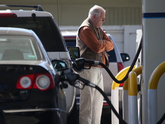 File: A customer pumps gasoline into his car at an Arco gas station on March 3, 2015 in Mill Valley.