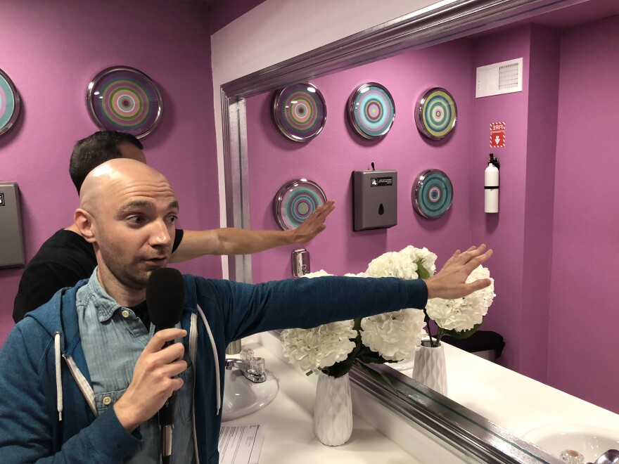 A Martinez and Tommy Honton test the mirror illusion at the Museum of Selfies.
