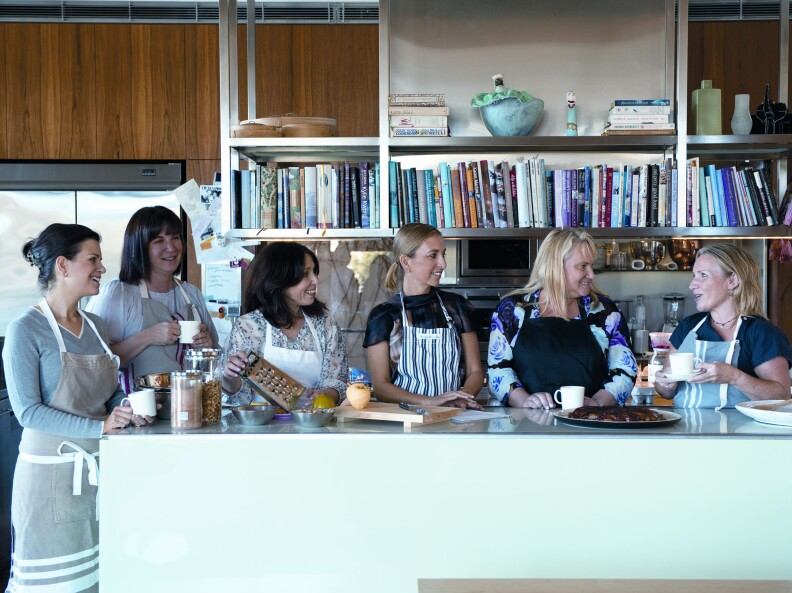 The Monday Morning Cooking Club gather round the kitchen table.