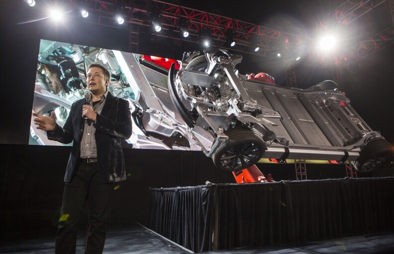 Elon Musk, CEO of Tesla Motors Inc., announces its new car Tesla "D"   in Hawthorne, Calif., Thursday, Oct. 9, 2014. (AP Photo/Ringo H.W. Chiu)