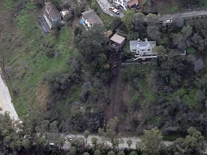 Photo from NBC4 shows home where part of patio became compromised due to recent rains and was at risk of falling down hill, onto Lauren Canyon Boulevard. The heavily traveled commuter route was closed until authorities could assess the situation.