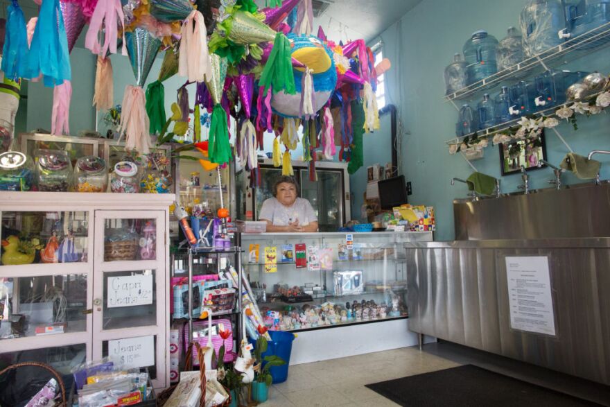 Lilia Perera and her husband own Agua Pura, a store that sells water and gifts across the street from the site of the future Walmart. The couple worries that they won't be able to compete with Walmart's low prices.