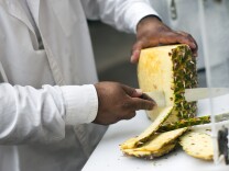 Delfino Flores cuts and prepares fruit outside his Highland Park home on Tuesday morning, Nov. 11, 2014.