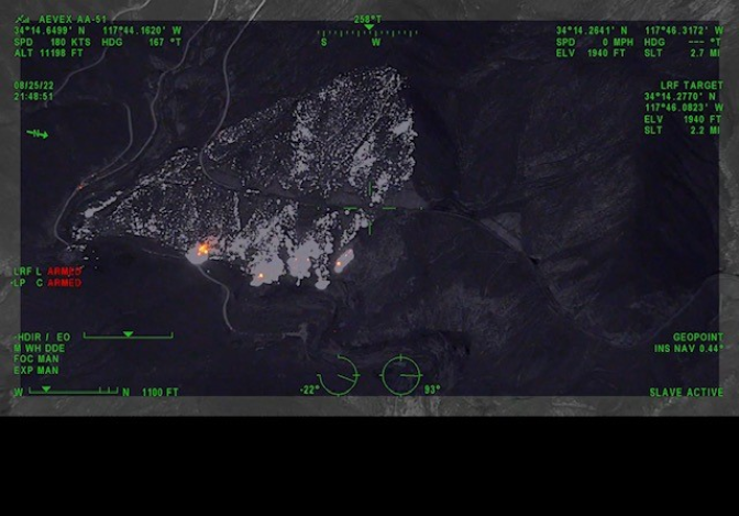 Fire activity is indicated by lighter spots on a dark satellite view.