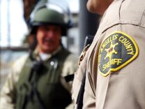 Officers from the Los Angeles County Sheriff's Department guard an intersection outside the Twin Towers Correctional Facility in Los Angeles on Feb. 8, 2013, following reports that murder suspect Christopher Dorner was seen in the area. The correctional facility and adjoining L.A. County Men's Central Jail were on high alert after the report, resulting in area traffic checkpoints conducted by officers in ballistic vests and helmets.