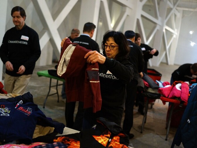 Volunteers sort coats at the annual New York Cares coat drive on December 16, 2013.
