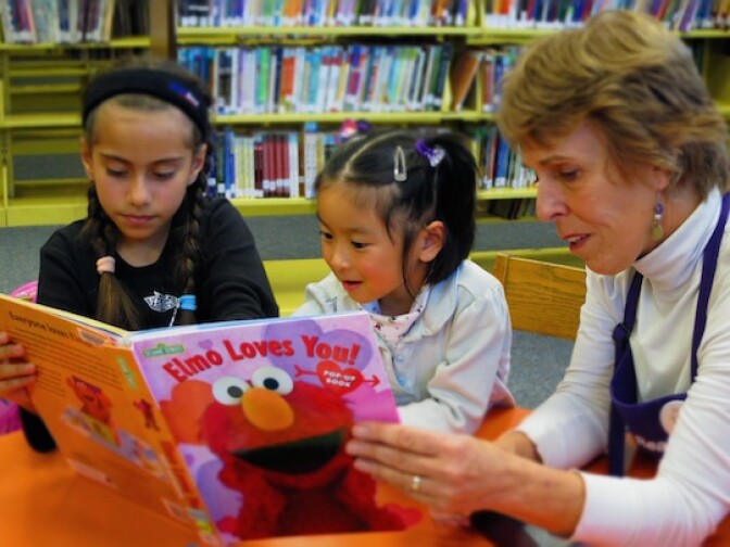 A volunteer with the LA Public Library's STAR program reading to children at the Eagle Rock Branch (March 2012). Adults will read to children in the community as a way to engage the community around reading.