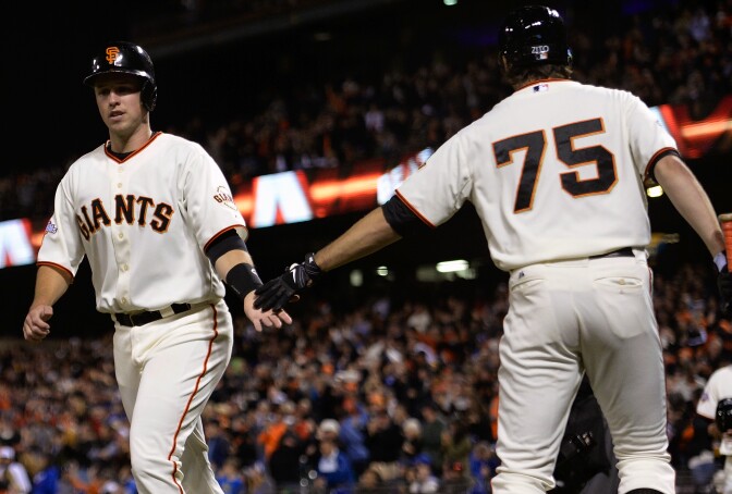 SAN FRANCISCO, CA - SEPTEMBER 25:  Buster Posey #28 of the San Francisco Giants is congratulated by Barry Zito #75 after Posey scored during the second inning against the Los Angeles Dodgers at AT&T Park on September 25, 2013 in San Francisco, California. Posey scored on a bases loaded triple from Tony Abreu. (Photo by Thearon W. Henderson/Getty Images)