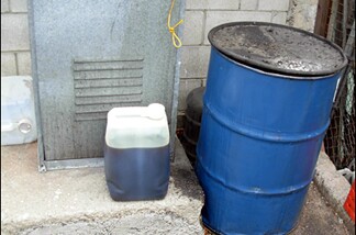 This innocent oil drum behind an LA restaurant contains liquid gold for John's converted car.