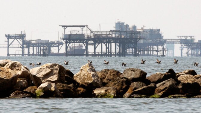 Helicopters that used to take thousands of employees out to drilling rigs like these off the coast of Port Fourchon, La., each month are now silent.