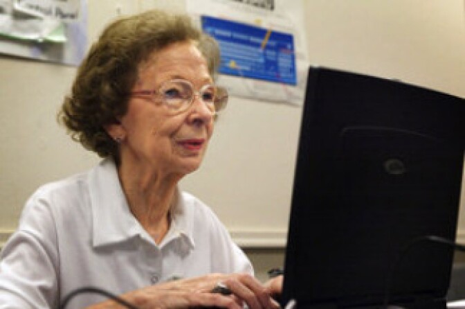 Suzette D'Hooghe, 77, works on her laptop computer during a computer class in Des Plaines, Ill., in 2003. Increasing numbers of people older than 50 are turning to social networking to share updates and connect with family and friends.  