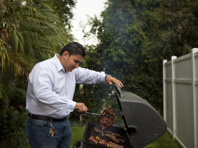 Los Angeles, CA: July 12, 2012 - Ronald Aldana has a cook-out in the front yard, of his home, with his family, in Los Angeles, CA.