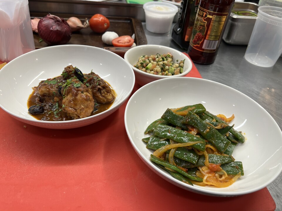 A colorful photo of cooked medium brown chicken, green romano beans and couscous.  