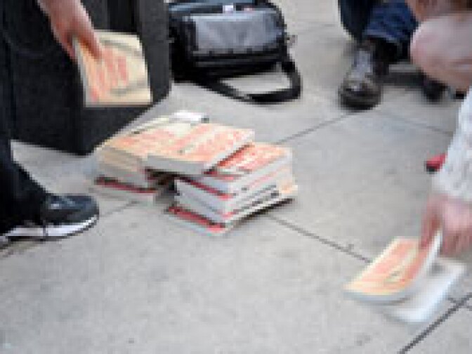 Author Dan Fante honored his father by offering a stack of his own work to the crowd, setting off a momentary frenzy as fans snapped up the books.