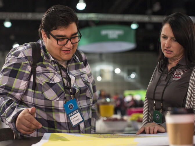 Raymond Gamez of Los Angeles looks at a map of the Papa John's stores near his home during the Los Angeles Opportunity Hiring Fair at the Los Angeles Convention Center on Thursday morning, Feb. 11, 2016.