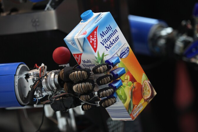 HANOVER, GERMANY - MARCH 06:  A robot developed by the Karlsruhe Institute of Technology retrieves a carton of juice in a presentation on the first day of the CeBIT 2012 technology trade fair on March 6, 2012 in Hanover, Germany. CeBIT 2012, the world's largest information technology trade fair, will run from March 6-10, and advances in cloud computing and security are major features this year.  (Photo by Sean Gallup/Getty Images)
