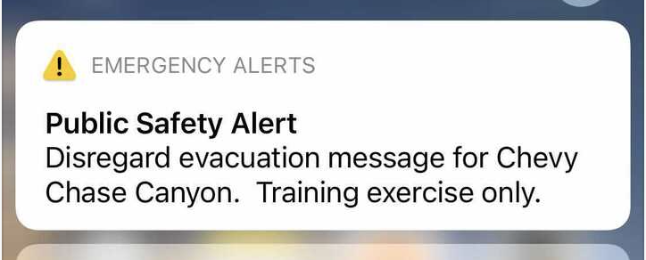 A text message reads Emergency Alerts Public Safety Alert Disregard evacuation for Chevy Chase Canyon. Training exercise only.