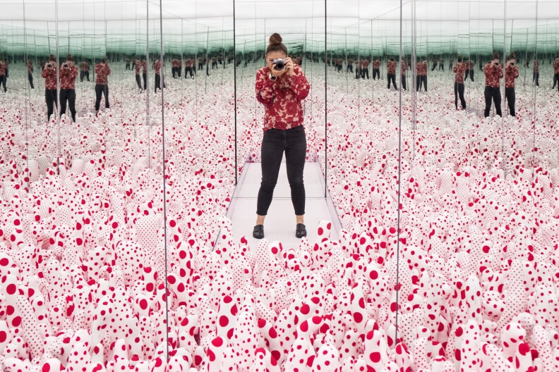 KPCC Visual Journalist Maya Sugarman takes pictures inside "Infinity Mirror Room–Phalli's Field," one of several rooms inside Yayoi Kusama's Infinity Mirrors which opens on Saturday at The Broad.