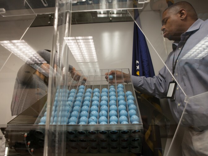 Cristine Nguyen (L) and Vince McClure (R) do final checks one one of the Selective Service Systems two draft lottery machines prior to their monthly test.