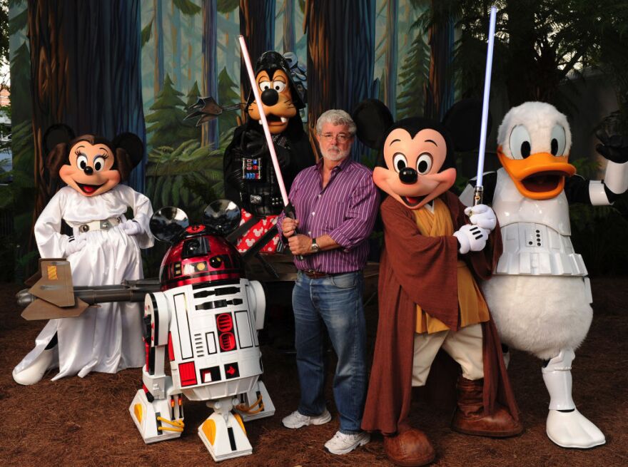 In this handout image provided by Disney, with the stern and determined look of a Jedi Knight, "Star Wars" creator and filmmaker George Lucas poses with a group of "Star Wars"-inspired Disney characters Aug. 14, 2010 at Disney's Hollywood Studios theme park in Lake Buena Vista, Fla.  Lucas is in central Florida for "Star Wars Celebration V," the official Lucasfilm fan event that is taking place this week at the Orange County Convention Center in Orlando, Fla. He visited Walt Disney World Resort tonight to attend Disney's "Last Tour to Endor" special event. 