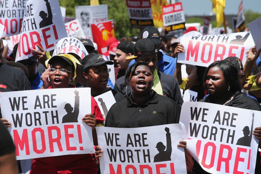 Fast food workers and activists demonstrate outside the McDonald's corporate campus on May 21, 2014 in Oak Brook, Illinois. The demonstrators were calling on McDonald's to pay a minimum wage of $15-per-hour and offer better working conditions for their employees. Several protestors were arrested after they entered and ignored police orders to leave the McDonald's campus.  McDonald's is scheduled to hold its annual shareholder's meeting tomorrow at the campus. 