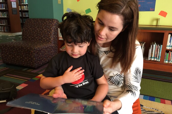 Lauren Child reads to her 3-year-old son Foster at the Central Public Library in downtown Los Angeles.
