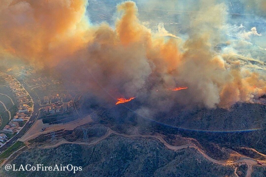 An aerial image shows the North Fire burning near homes in the Santa Clarita area