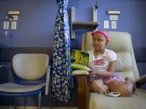 Isabella Osorio, 9, affected by cancer, rests during her chemotherapy session. Recent research suggests existence of cancer stem-cells.